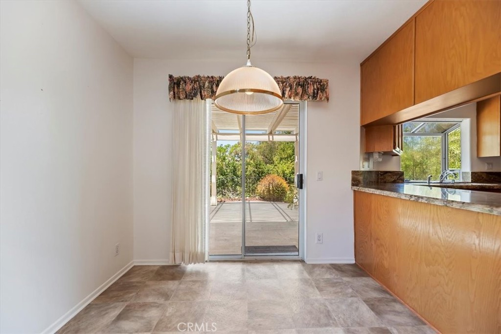 39973 Corte Lorca Murrieta, CA 92562 - Photo 18 of 72 a view of a kitchen with wooden floor and a outdoor space