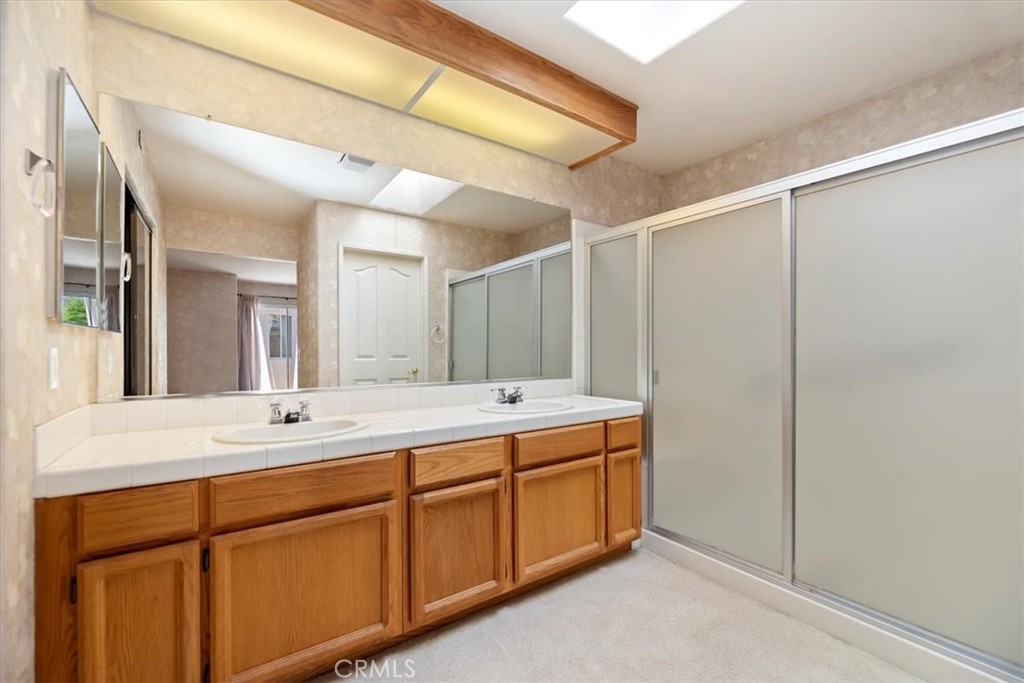 39973 Corte Lorca Murrieta, CA 92562 - Photo 26 of 72 a bathroom with a double vanity sink and mirror