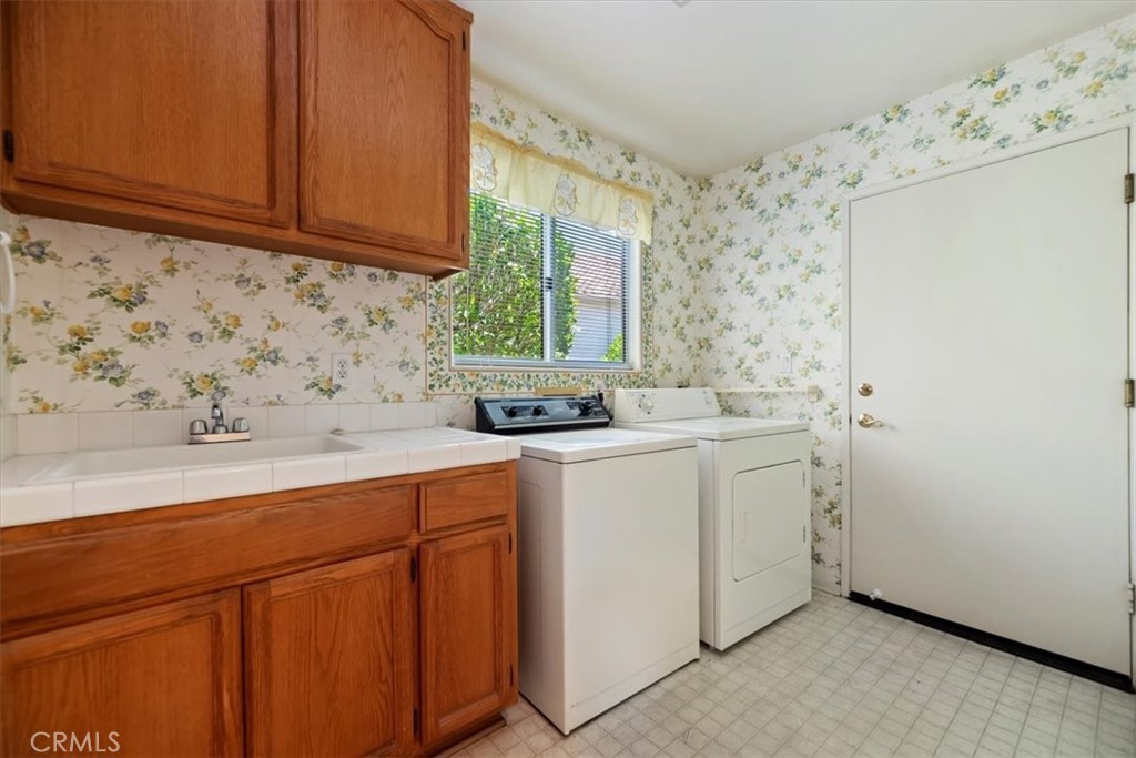 39973 Corte Lorca Murrieta, CA 92562 - Photo 27 of 72 Laundry with a Sink and Storage Cabinets