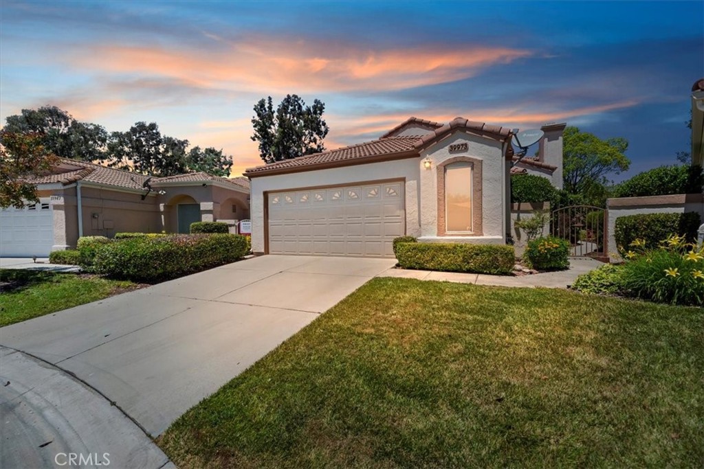 39973 Corte Lorca Murrieta, CA 92562 - Photo 45 of 72 a front view of a house with a yard and garage