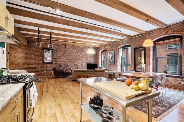 a very nice looking living room with a large window and furniture