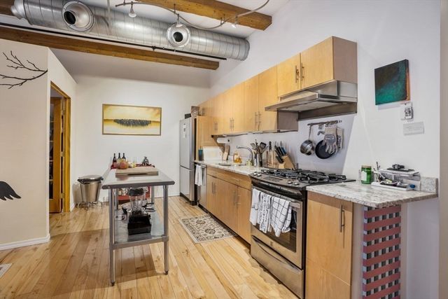 a kitchen with stainless steel appliances granite countertop a stove and a sink