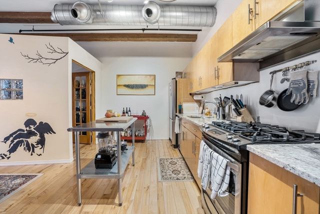 a kitchen with granite countertop a stove and a sink