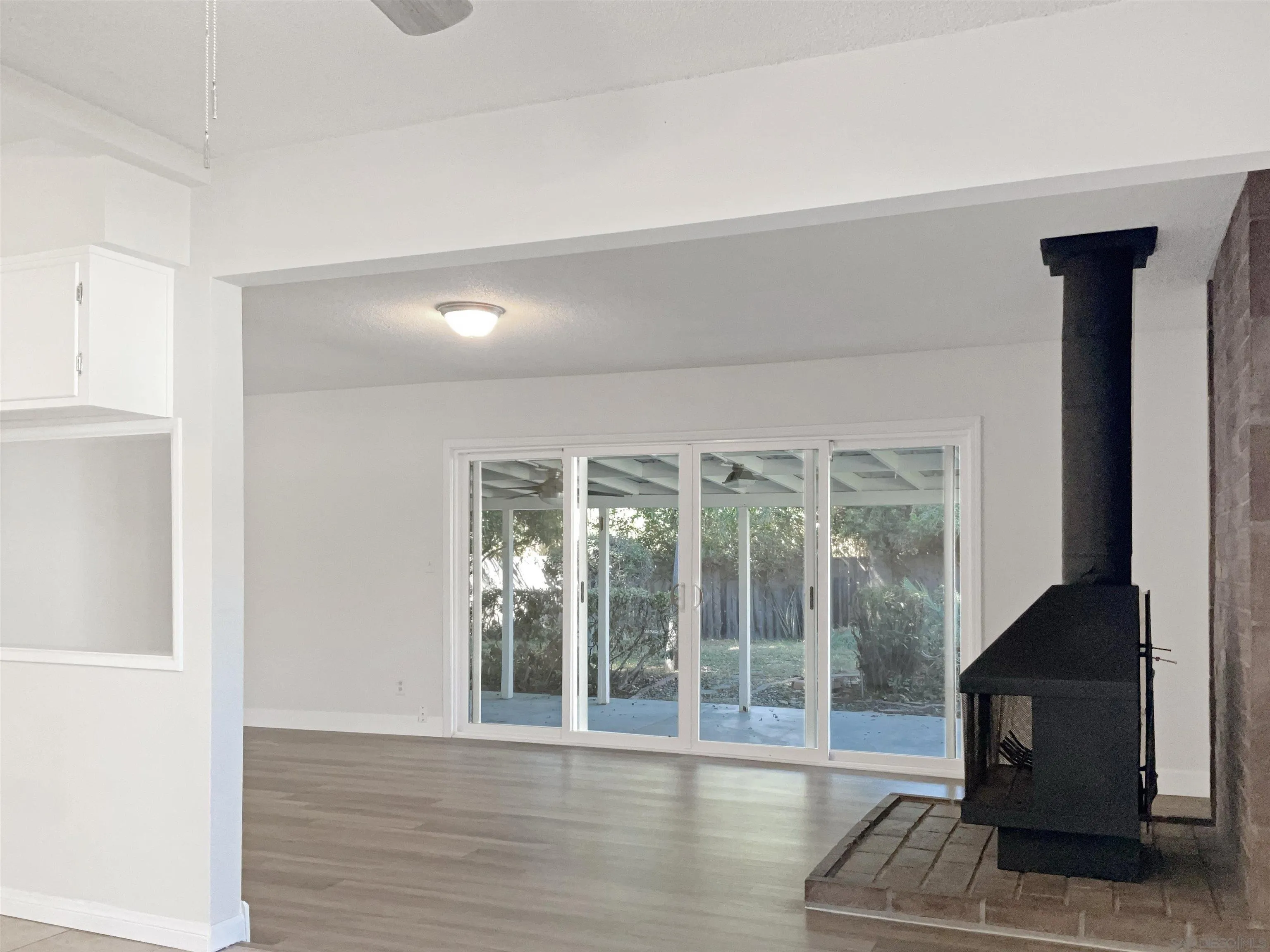2850 Skyline Drive Lemon Grove, CA 91945 - Photo 3 of 17 a view of a livingroom with wooden floor and a fireplace