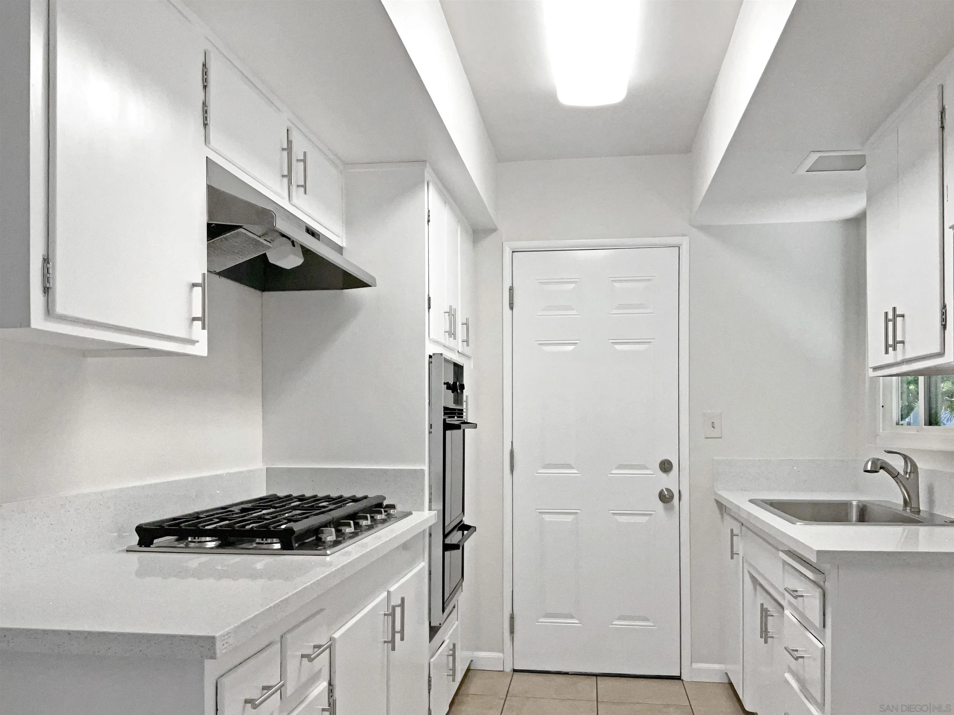 2850 Skyline Drive Lemon Grove, CA 91945 - Photo 9 of 17 a kitchen with stainless steel appliances a sink stove and refrigerator