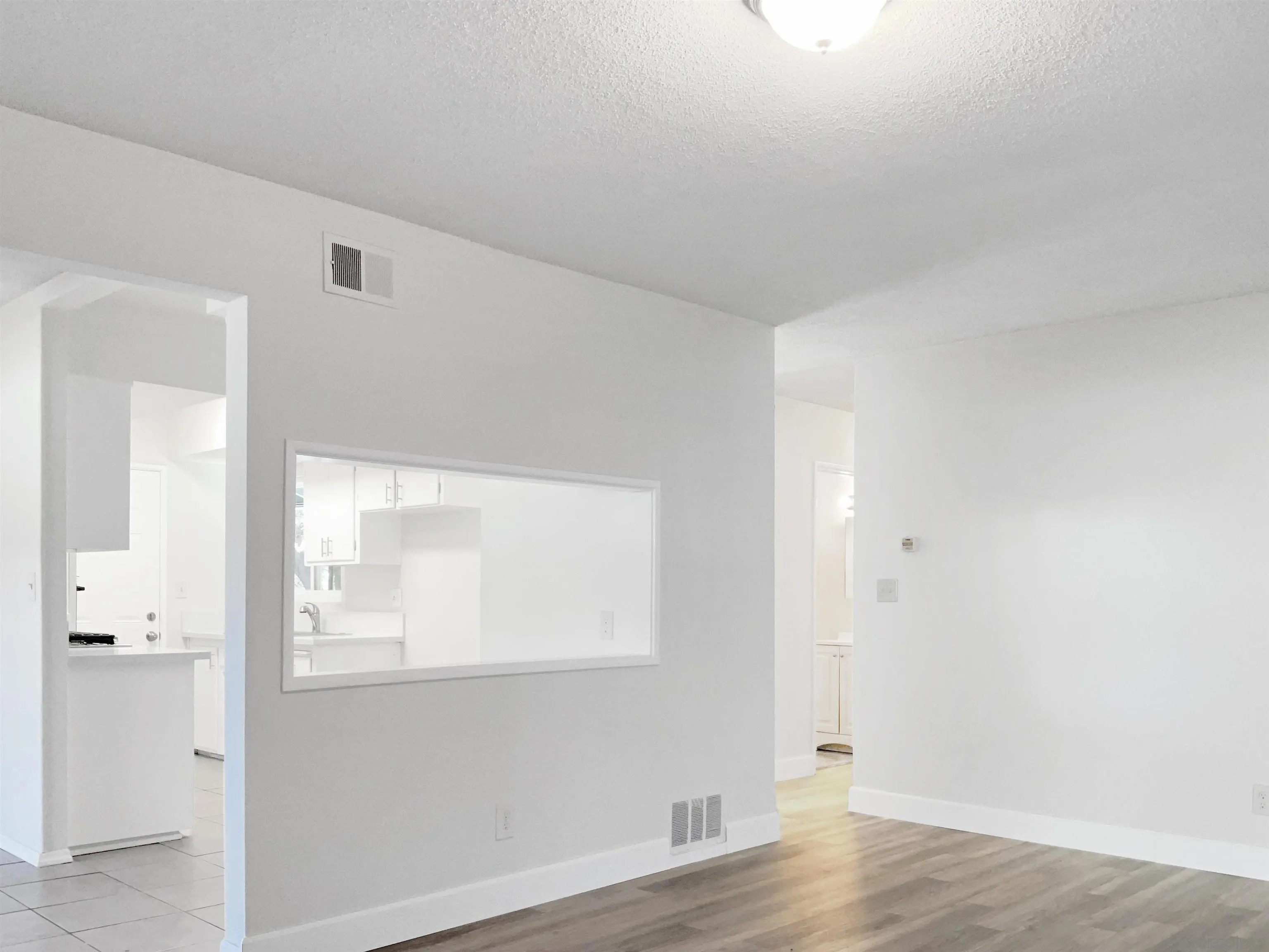 2850 Skyline Drive Lemon Grove, CA 91945 - Photo 10 of 17 an empty room with wooden floor and windows