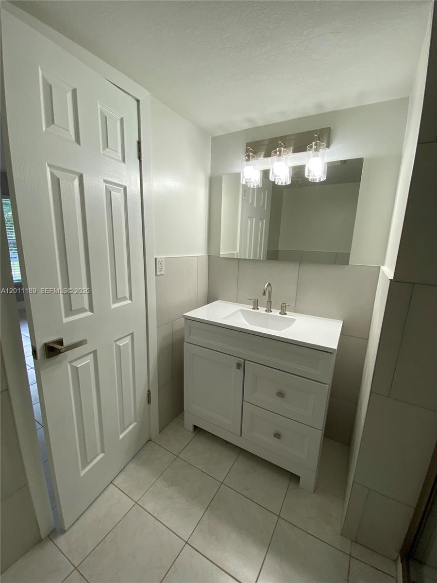 455 South Pine Island Road, Unit 110C Plantation, FL 33324 - Photo 15 of 30 a bathroom with a double vanity sink and mirror