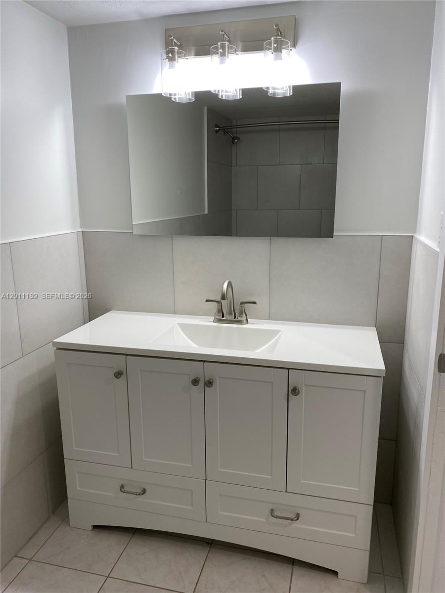 455 South Pine Island Road, Unit 110C Plantation, FL 33324 - Photo 22 of 30 a bathroom with a sink vanity and mirror