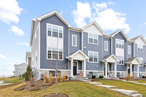 a front view of a residential houses with yard