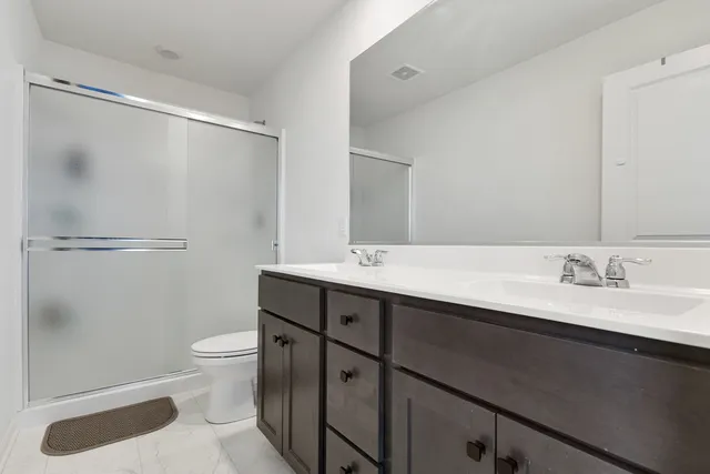 a bathroom with a sink a toilet and a mirror