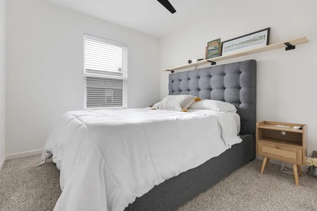 a bedroom with a bed and a chair