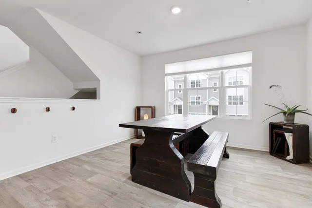 a view of a workspace with furniture and wooden floor