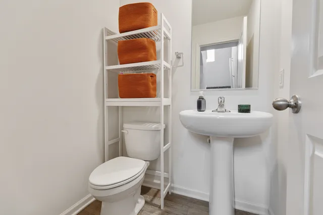 a bathroom with a toilet sink and mirror