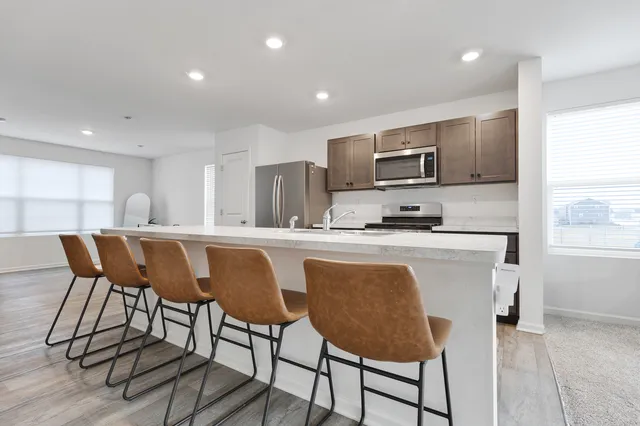 a kitchen with a dining table chairs and microwave