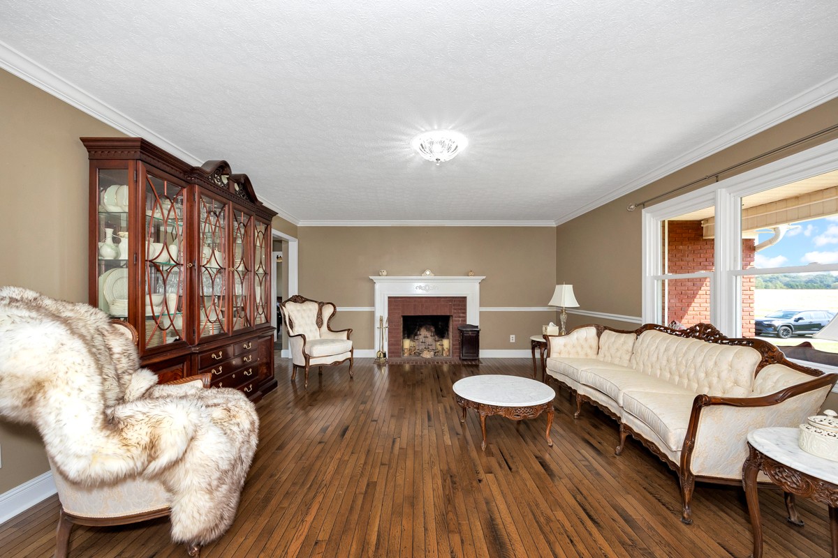 18563 Yarbrough Road Athens, AL 35613 - Photo 9 of 42 a living room with furniture a fireplace and a large window