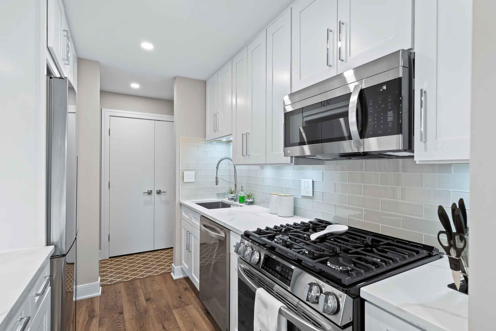 1207 South Old Wilke Road, Unit 209 Rolling Meadows, IL 60005 - Photo 3 of 22 a kitchen with stainless steel appliances a stove a microwave and cabinets