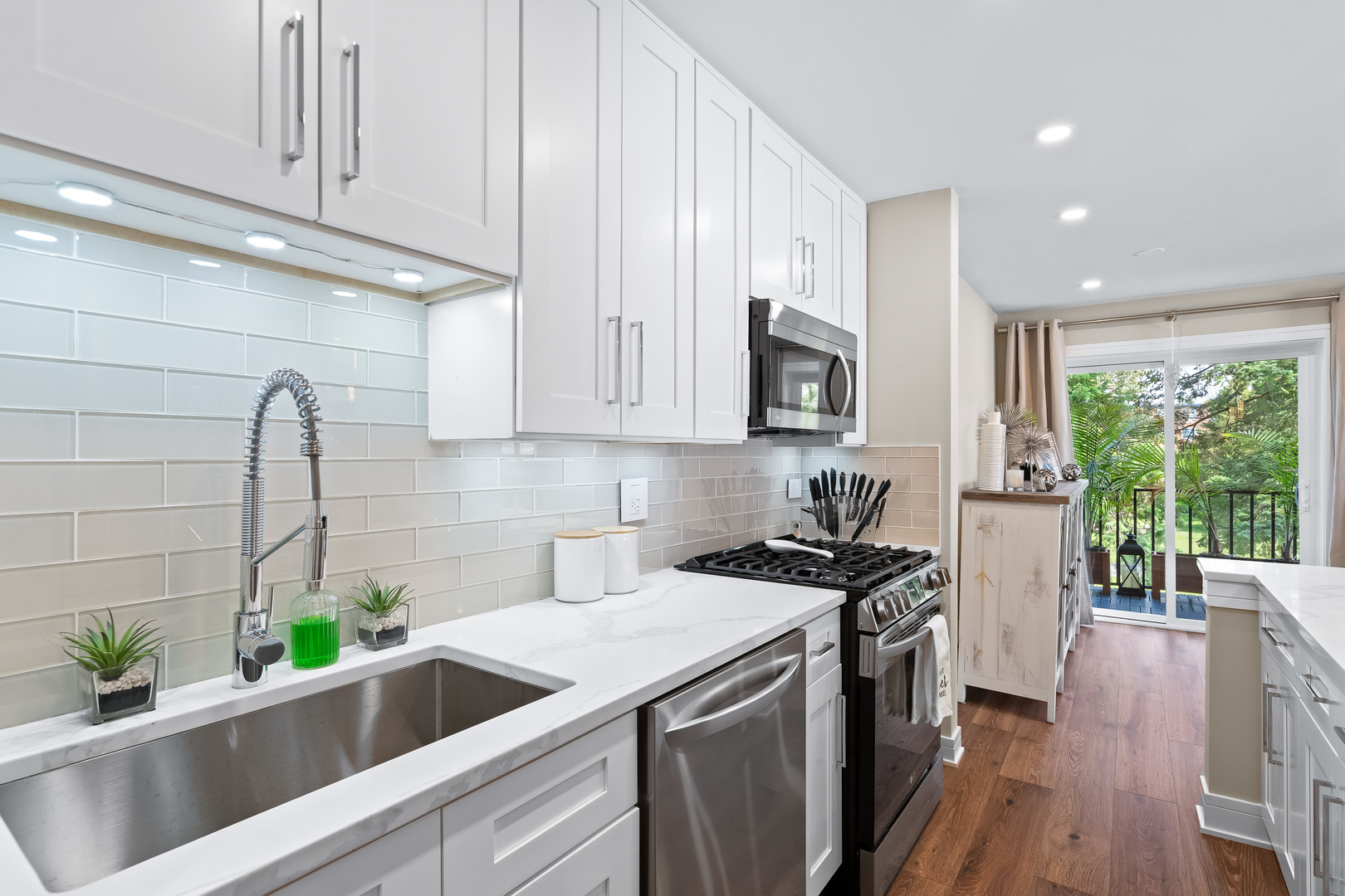1207 South Old Wilke Road, Unit 209 Rolling Meadows, IL 60005 - Photo 4 of 22 a kitchen that has a lot of cabinets and wooden floor