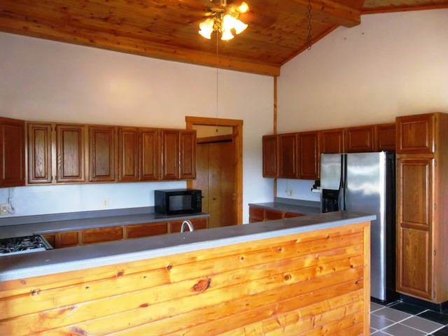 3588 South Butternut Road Oregon, IL 61061 - Photo 8 of 30 a kitchen with kitchen island granite countertop a sink cabinets and stainless steel appliances