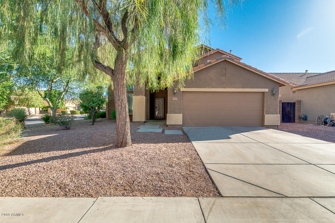 15917 West Calavar Road Surprise, AZ 85379 - Photo 1 of 40 a view of a house with a yard and large tree