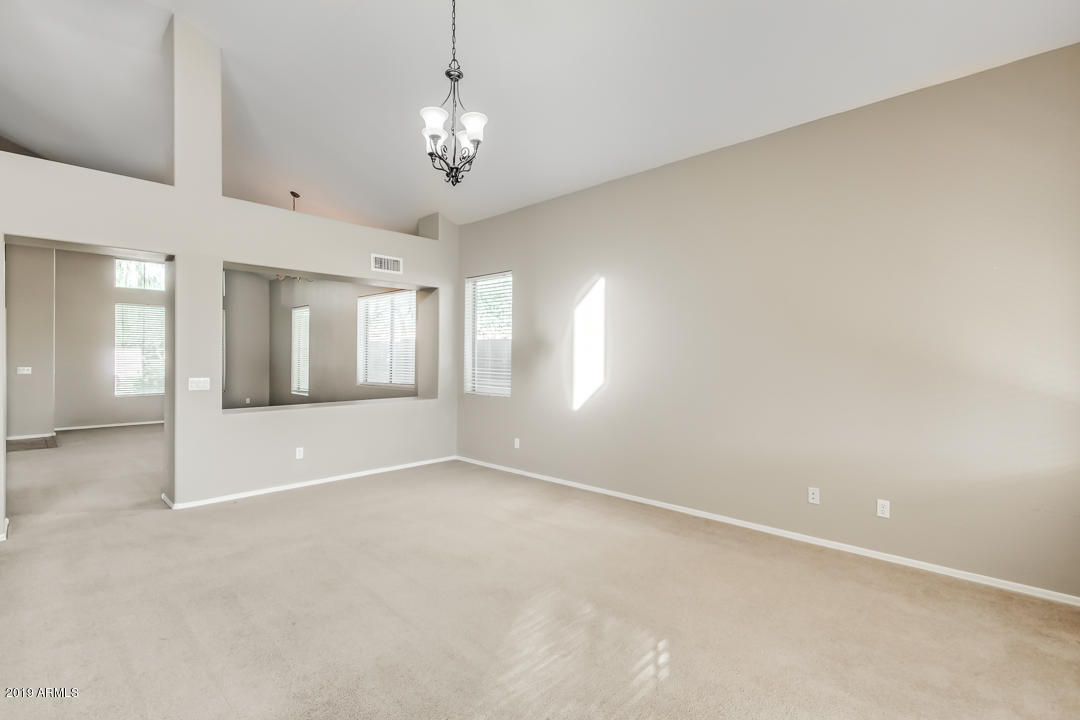 15917 West Calavar Road Surprise, AZ 85379 - Photo 14 of 40 wooden floor in an empty room with a window