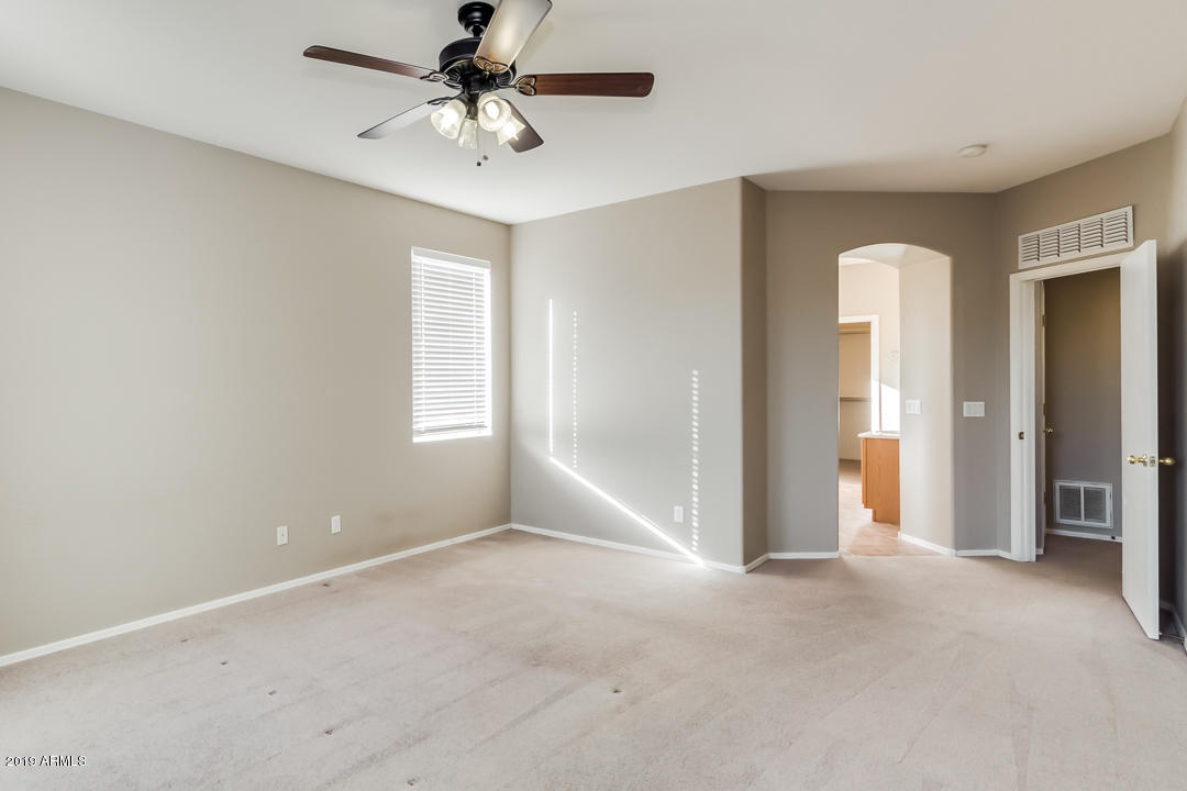 15917 West Calavar Road Surprise, AZ 85379 - Photo 16 of 40 a view of a big room with windows and chandelier fan
