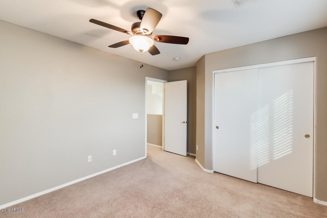 15917 West Calavar Road Surprise, AZ 85379 - Photo 22 of 40 an empty room with a window and a ceiling fan