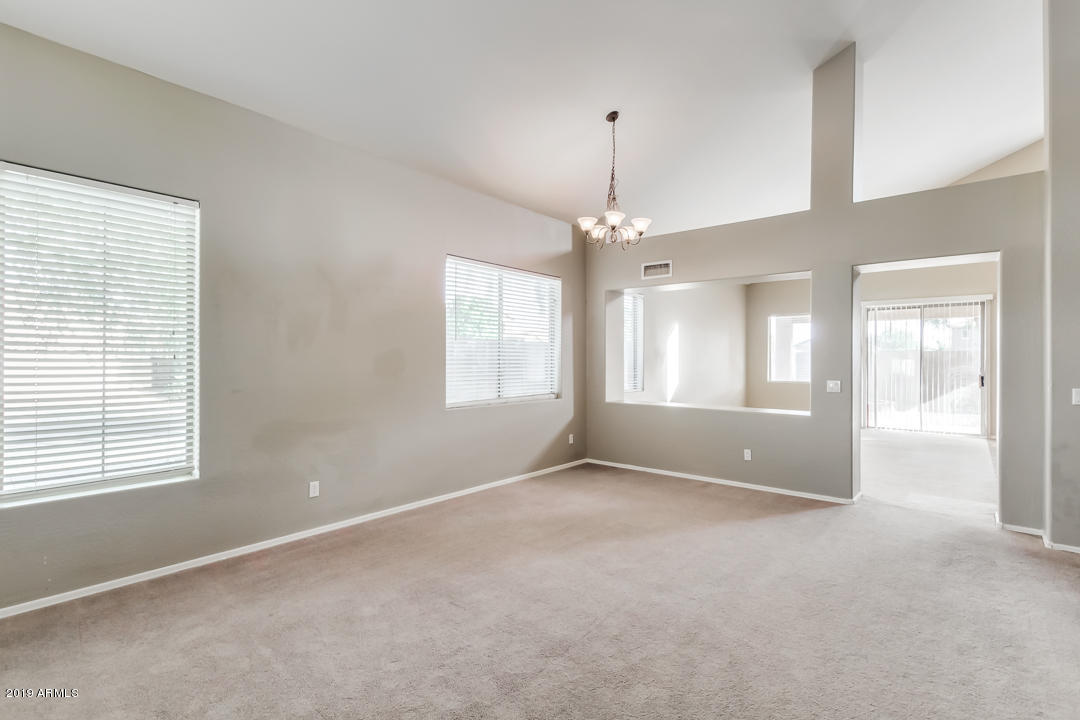 15917 West Calavar Road Surprise, AZ 85379 - Photo 34 of 40 a view of an empty room with chandelier and window