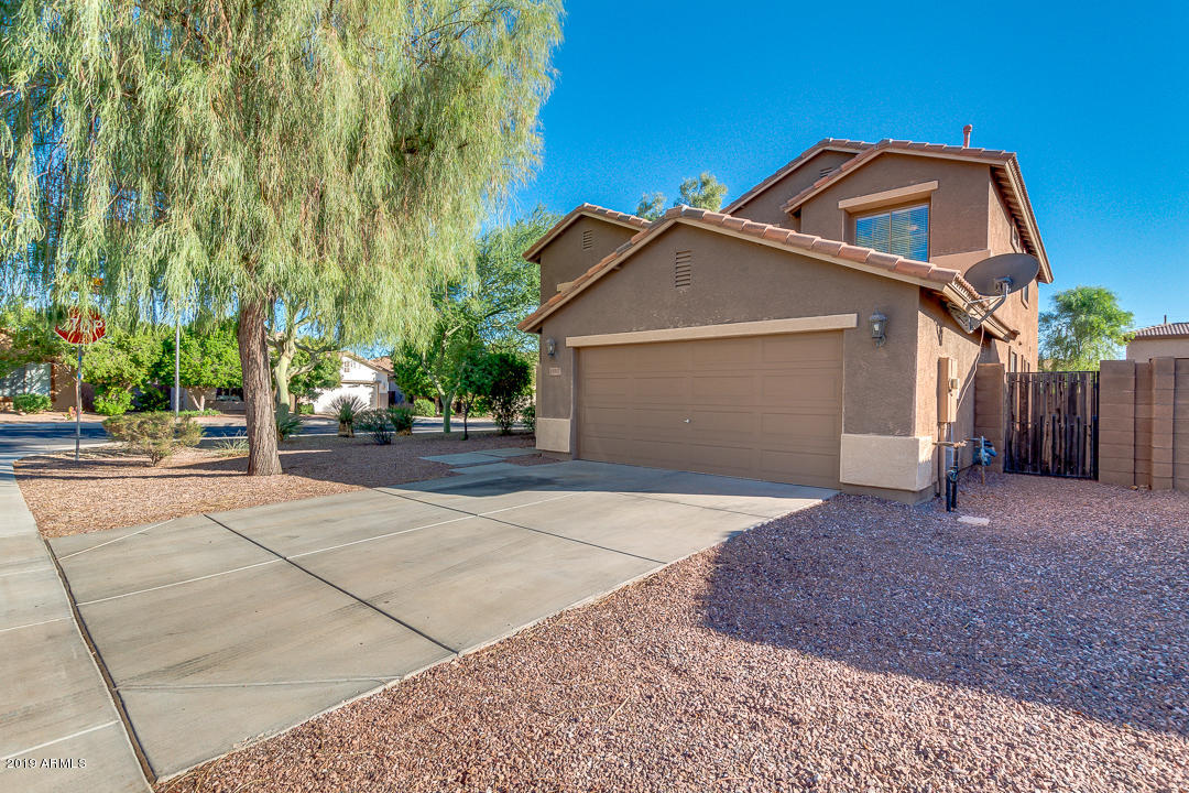 15917 West Calavar Road Surprise, AZ 85379 - Photo 40 of 40 a front view of a house with a yard and garage
