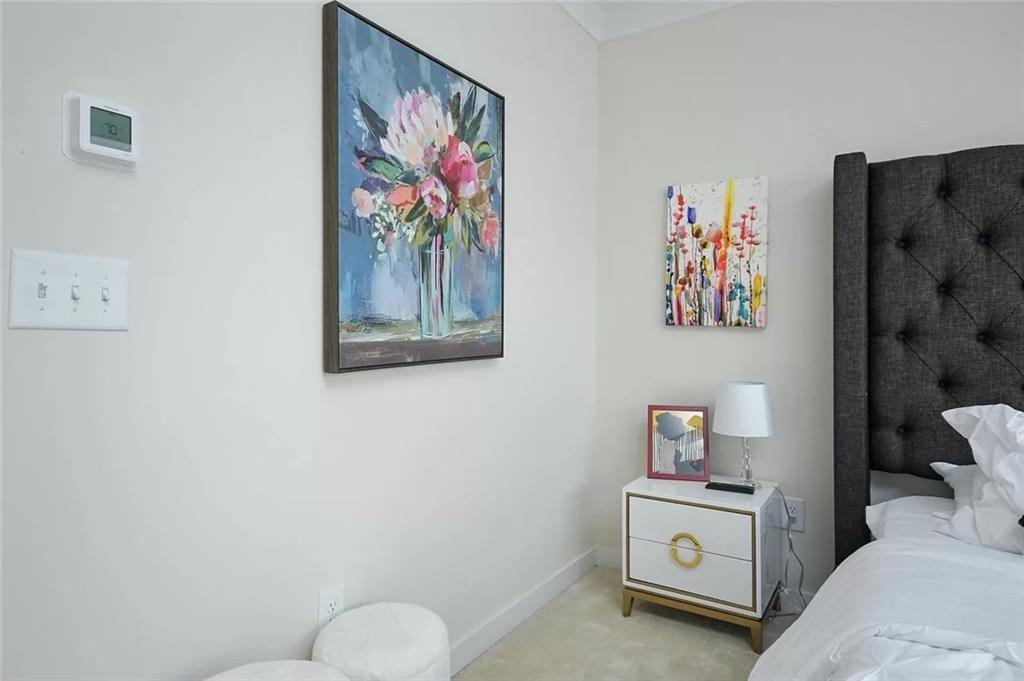 2048 Holtz Lane Atlanta, GA 30318 - Photo 13 of 27 a bedroom with a bed and painting on the wall