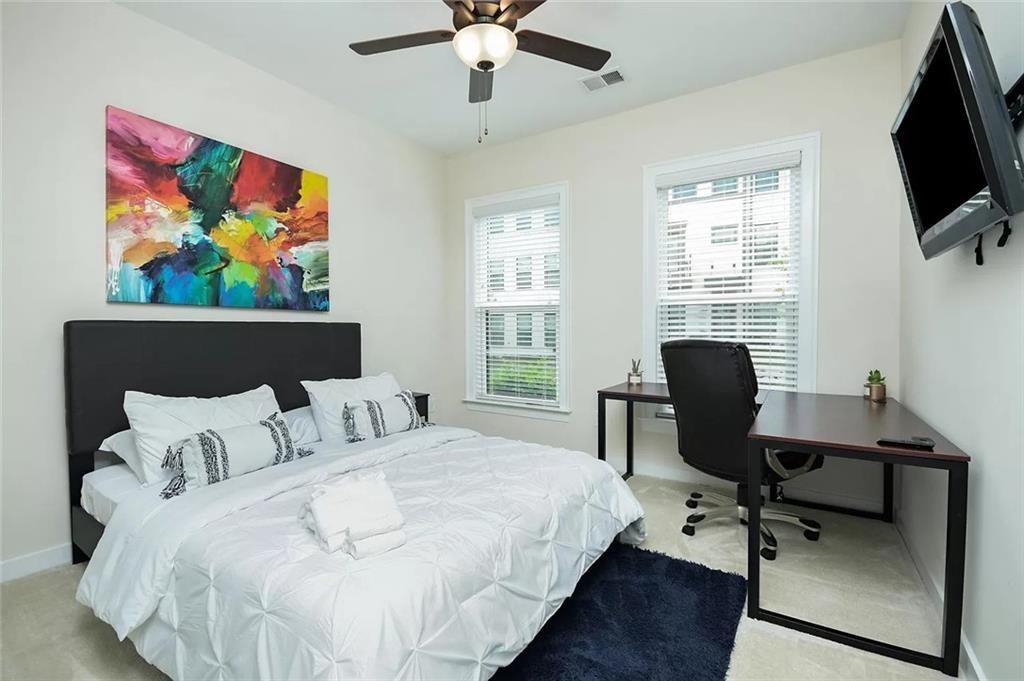 2048 Holtz Lane Atlanta, GA 30318 - Photo 14 of 27 a bedroom with a bed and a desk