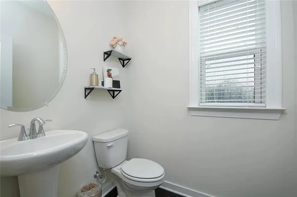 a bathroom with a sink mirror and toilet