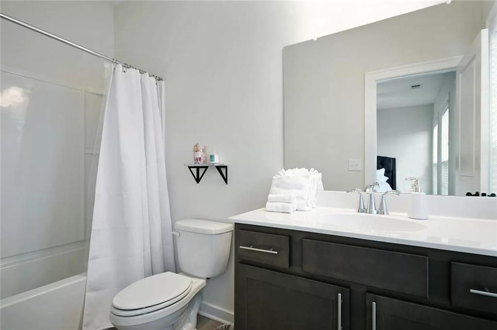 2048 Holtz Lane Atlanta, GA 30318 - Photo 20 of 27 a bathroom with a sink a toilet and shower