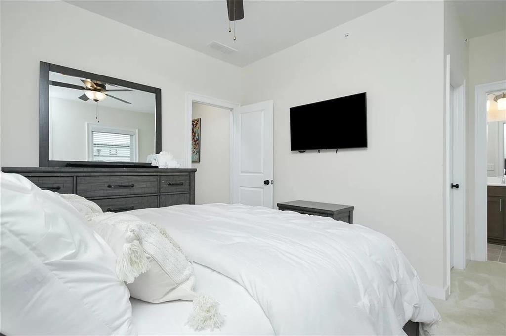 2048 Holtz Lane Atlanta, GA 30318 - Photo 21 of 27 a bedroom with a bed and a flat screen tv