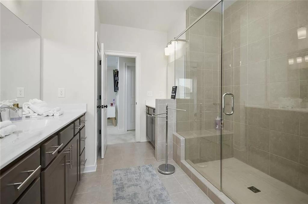 2048 Holtz Lane Atlanta, GA 30318 - Photo 22 of 27 a spacious bathroom with a shower sink and mirror