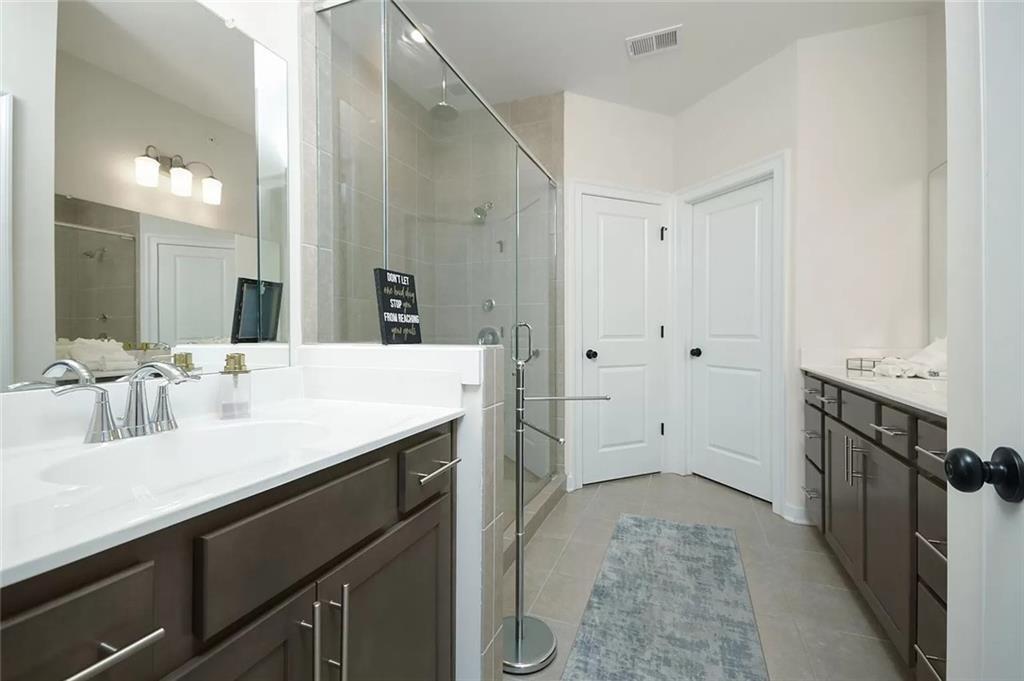 2048 Holtz Lane Atlanta, GA 30318 - Photo 24 of 27 a bathroom with a sink and a mirror