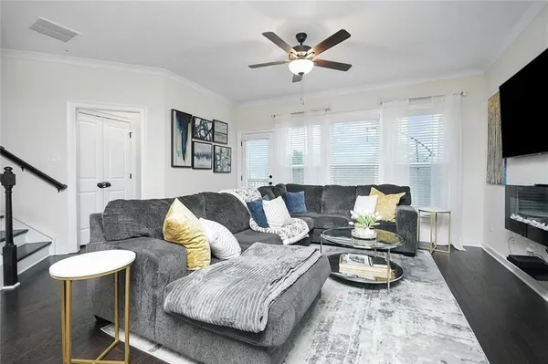 a living room with furniture and a flat screen tv
