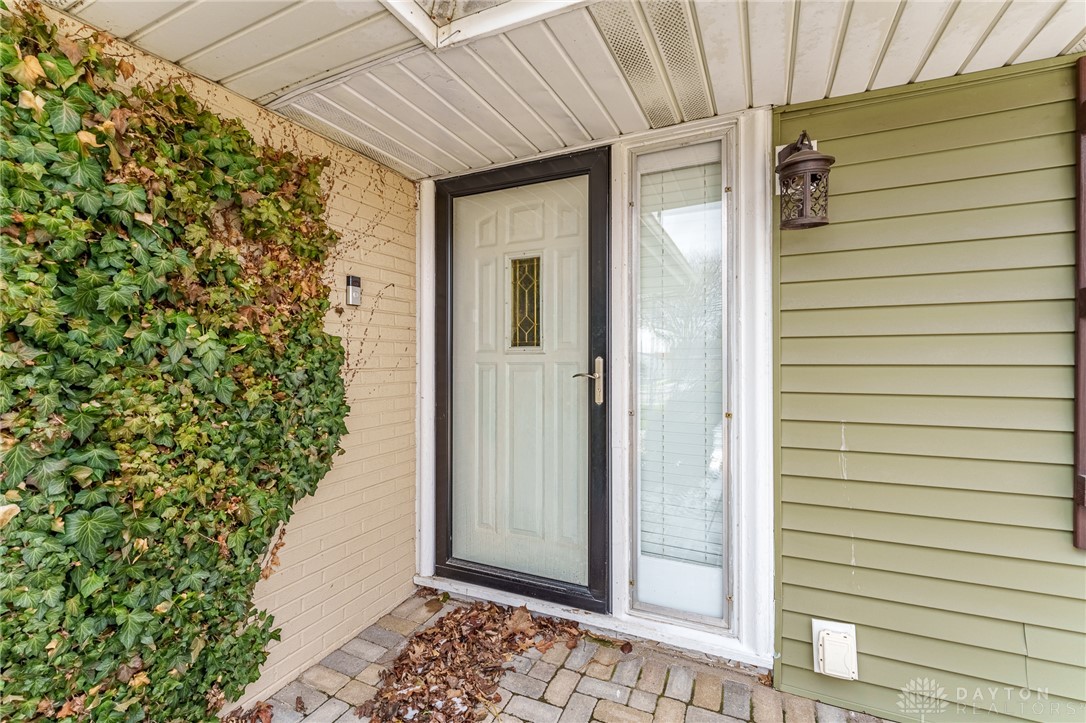 305 South Vandemark Road Sidney, OH 45365 - Photo 11 of 32 This charming home offers a welcoming entrance with a classic door and inviting outdoor light.