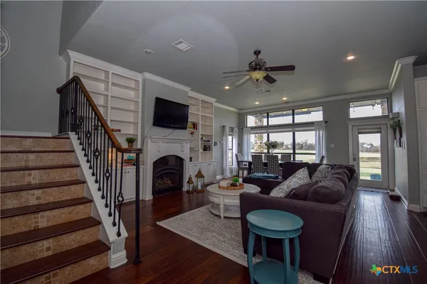 a living room with furniture a flat screen tv and a fireplace