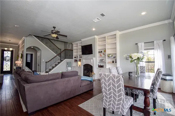 a living room with furniture a fireplace and a flat screen tv