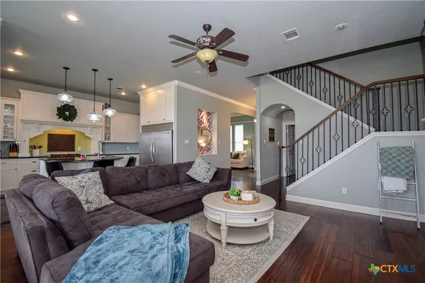 a living room with furniture and a chandelier