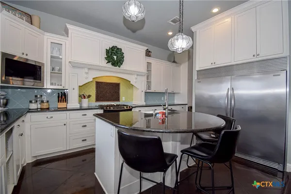 a kitchen with cabinets a sink and appliances