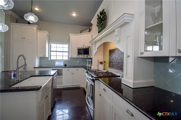 a kitchen that has a sink and a stove