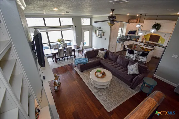 a living room with furniture and a floor to ceiling window