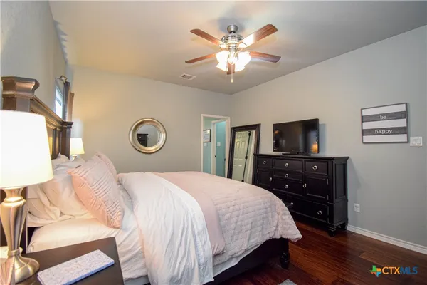 a bedroom with a bed and a chandelier