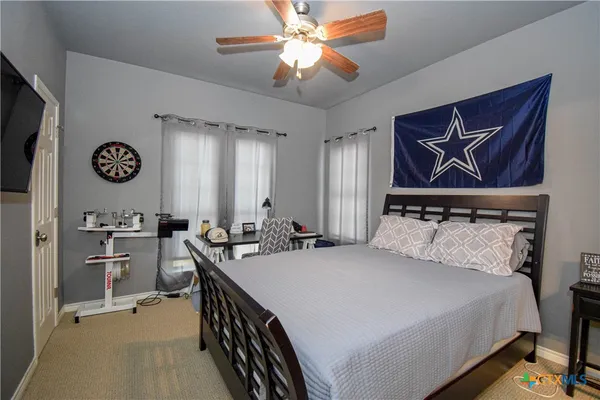 a bed room with two beds and a flat screen tv