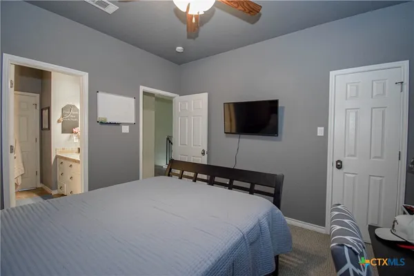 a bathroom with a granite countertop sink a mirror and a shower