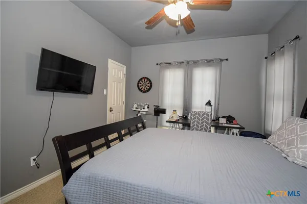 a bed room with a bed and a chair