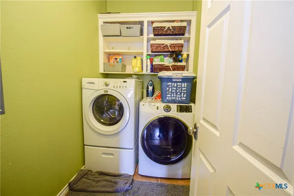 a bedroom with a bed window and a flat screen tv