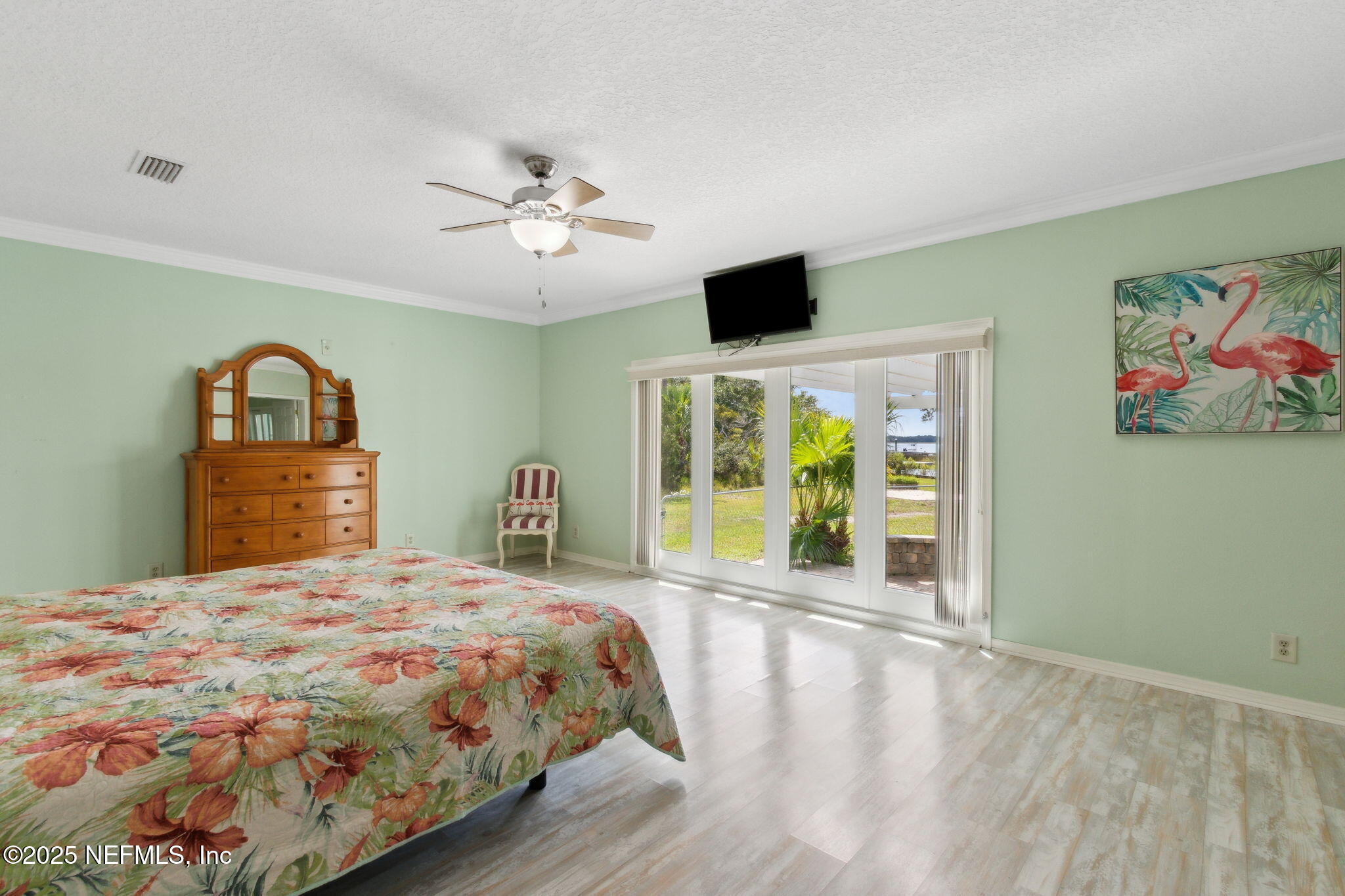 16062 Shark Road West Jacksonville, FL 32226 - Photo 11 of 43 a bedroom with a large bed and a large window
