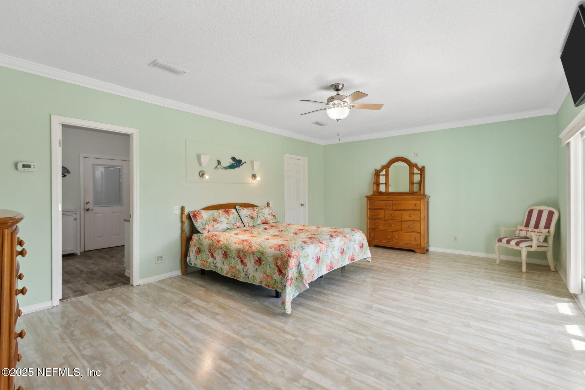 16062 Shark Road West Jacksonville, FL 32226 - Photo 12 of 43 a spacious bedroom with a bed and a table in it